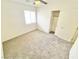 Bright bedroom with a ceiling fan, plush carpet, closet, and a window with blinds at 8748 Tomnitz Ave # 103, Las Vegas, NV 89178