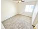 Comfortable bedroom featuring neutral carpeting, ceiling fan, and ample natural light at 8748 Tomnitz Ave # 103, Las Vegas, NV 89178