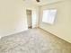Bedroom featuring plush carpet, a window, a ceiling fan, and closet with sliding doors at 8748 Tomnitz Ave # 103, Las Vegas, NV 89178