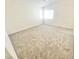 Bright bedroom features soft carpet, neutral walls, and ample natural light from a large window at 8748 Tomnitz Ave # 103, Las Vegas, NV 89178