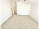 This is a carpeted bedroom with vaulted ceilings, access to closet and adjacent room at 8748 Tomnitz Ave # 103, Las Vegas, NV 89178