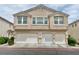 Inviting two-story townhome showcasing attached garages and well-maintained landscaping at 8748 Tomnitz Ave # 103, Las Vegas, NV 89178