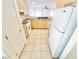 Efficient kitchen boasts ample cabinet space, white appliances, and tiled flooring at 8748 Tomnitz Ave # 103, Las Vegas, NV 89178