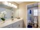 Well-lit bathroom featuring a vanity, toilet, shower with curtain, and decorative accents at 9446 Bondeno St, Las Vegas, NV 89123