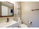 Clean and modern bathroom with a white vanity, toilet, and framed mirror at 9446 Bondeno St, Las Vegas, NV 89123