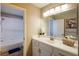 Bright bathroom featuring a spacious vanity, decorative plant, and walk-in shower at 9446 Bondeno St, Las Vegas, NV 89123
