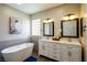 Elegant bathroom with a standalone tub, double vanity, and contemporary fixtures at 9446 Bondeno St, Las Vegas, NV 89123