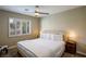 Bright bedroom featuring a comfortable king-sized bed, neutral decor, and a window with shutters at 9446 Bondeno St, Las Vegas, NV 89123