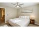 Comfortable bedroom featuring a ceiling fan, soft lighting, and decorative artwork at 9446 Bondeno St, Las Vegas, NV 89123