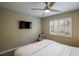 Cozy bedroom with a queen-sized bed, a ceiling fan, and plantation shutters on the window at 9446 Bondeno St, Las Vegas, NV 89123