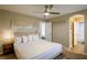 Inviting bedroom featuring a neutral color scheme, ensuite bathroom, and stylish ceiling fan at 9446 Bondeno St, Las Vegas, NV 89123
