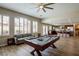 Entertainment space with a pool table and view into the modern kitchen at 9446 Bondeno St, Las Vegas, NV 89123
