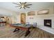 Inviting game room with a pool table and fireplace, creating a cozy atmosphere at 9446 Bondeno St, Las Vegas, NV 89123