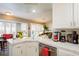 Well-lit kitchen with white cabinetry, stainless steel appliances, and a cozy breakfast nook at 9564 Summer Cypress St, Las Vegas, NV 89123