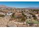 Aerial view showing putting green, pool, tennis court, house and mountain views at 9801 Orient Express Ct, Las Vegas, NV 89145