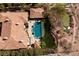 Aerial view of estate featuring a private pool, putting green, red tiled roof, and beautifully landscaped grounds at 9801 Orient Express Ct, Las Vegas, NV 89145