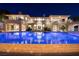 Backyard view highlighting the pool, patio area, and architectural details of the home at twilight at 9801 Orient Express Ct, Las Vegas, NV 89145