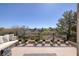 Expansive balcony with comfortable white seating and scenic views of the hillside at 9801 Orient Express Ct, Las Vegas, NV 89145