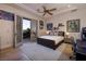 Well-lit bedroom with a decorative rug and personal decor, with access to the balcony at 9801 Orient Express Ct, Las Vegas, NV 89145
