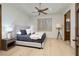 Bright bedroom with a ceiling fan, hardwood floors, and a comfy bed with stylish linens at 9801 Orient Express Ct, Las Vegas, NV 89145