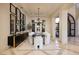 Formal dining room with stylish chandelier, ample seating, and elegant decor, ideal for hosting dinner parties at 9801 Orient Express Ct, Las Vegas, NV 89145