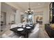 Formal dining room with an ornate chandelier, table set for a meal, and elegant decor and neutral colors at 9801 Orient Express Ct, Las Vegas, NV 89145