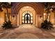 Elegant entryway with stone archway, double doors, and ornate details, creating a welcoming ambiance at 9801 Orient Express Ct, Las Vegas, NV 89145