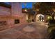 Impressive entrance showcasing the stone facade, arched doorway, and lush greenery, enhancing curb appeal at 9801 Orient Express Ct, Las Vegas, NV 89145