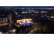 A luxurious estate illuminated at night, featuring a sparkling pool, manicured landscaping, and stunning architectural design at 9801 Orient Express Ct, Las Vegas, NV 89145