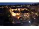 Grand estate illuminated at night showcases circular driveway and elegant architecture, exuding sophistication and curb appeal at 9801 Orient Express Ct, Las Vegas, NV 89145