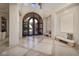 Spacious foyer with marble flooring, arched doorway, and stylish accents, creating a grand entrance at 9801 Orient Express Ct, Las Vegas, NV 89145