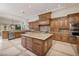 A stunning kitchen with stainless steel appliances, wood cabinets, a central island, and tile flooring at 9801 Orient Express Ct, Las Vegas, NV 89145