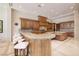 A spacious kitchen boasting wooden cabinets, granite countertops, and a large island at 9801 Orient Express Ct, Las Vegas, NV 89145