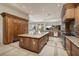 Spacious kitchen with wood cabinets, stainless appliances, a large island, and tile floors at 9801 Orient Express Ct, Las Vegas, NV 89145