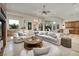 Open-concept living room featuring plush seating, a cozy rug, and lots of natural light and tile floors at 9801 Orient Express Ct, Las Vegas, NV 89145