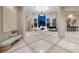 Elegant living room featuring high ceilings, large windows, fireplace, and stylish decor for a sophisticated ambiance at 9801 Orient Express Ct, Las Vegas, NV 89145