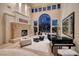 Bright living room with fireplace, piano, and ample seating, perfect for entertaining guests or relaxing at 9801 Orient Express Ct, Las Vegas, NV 89145