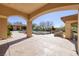 A spacious outdoor patio with stamped concrete overlooks a beautiful pool, landscaping, and architectural details at 9801 Orient Express Ct, Las Vegas, NV 89145