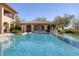 Beautiful swimming pool area with a view of the home, landscaping, and sports court at 9801 Orient Express Ct, Las Vegas, NV 89145