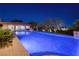 Stunning pool at night with elegant lighting and landscaping at 9801 Orient Express Ct, Las Vegas, NV 89145