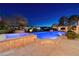 Backyard view of a sparkling pool and hot tub, with a lush garden at 9801 Orient Express Ct, Las Vegas, NV 89145