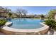 A tranquil swimming pool surrounded by well-maintained landscaping offering a peaceful and serene backyard oasis at 9801 Orient Express Ct, Las Vegas, NV 89145