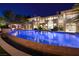 Backyard features a stunning pool with an attached bar and lush landscaping at 9801 Orient Express Ct, Las Vegas, NV 89145