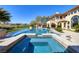A luxurious swimming pool with an attached hot tub offers a tranquil backyard setting with a clear view of the sky at 9801 Orient Express Ct, Las Vegas, NV 89145