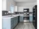 Updated kitchen featuring stainless steel appliances, tile floors, and blue lower cabinets at , Las Vegas, NV 89108