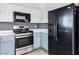 Traditional-style kitchen with stainless steel appliances and a black refrigerator at , Las Vegas, NV 89108