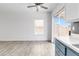 Living room with tile floors, ceiling fan, view to backyard, and access to kitchen at , Las Vegas, NV 89108