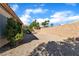 Backyard with desert landscaping and block wall, offering privacy and space at 10408 Georgetown Pl, Las Vegas, NV 89134