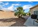 Landscaped backyard with palm tree, low maintenance gravel, and patio at 10408 Georgetown Pl, Las Vegas, NV 89134