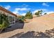 Spacious backyard with desert landscaping and a privacy wall offering a blank canvas at 10408 Georgetown Pl, Las Vegas, NV 89134